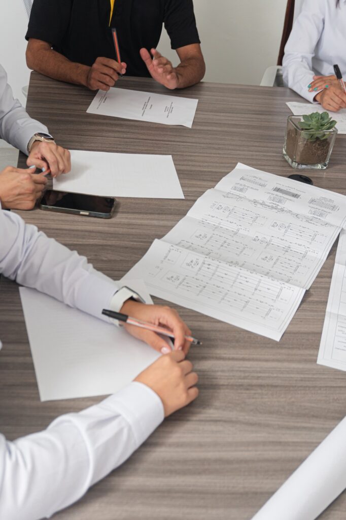 Professionals take notes and discuss projects to execute